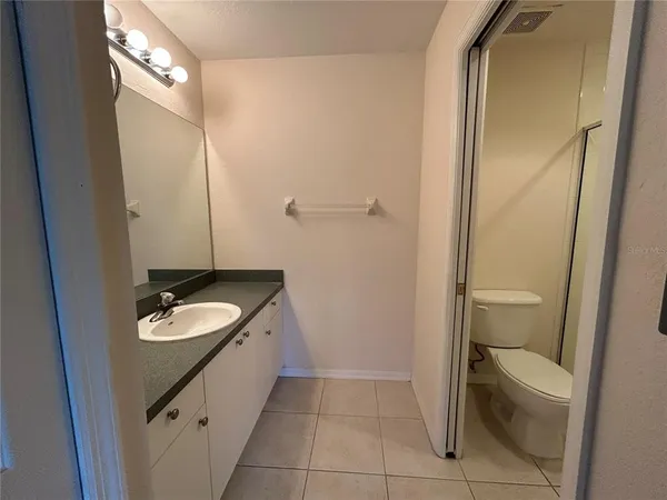 a bathroom with a shower a toilet and a sink