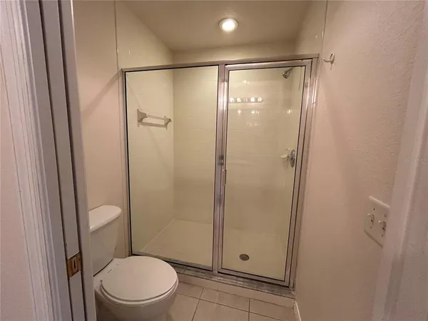 a bathroom with a shower and a toilet