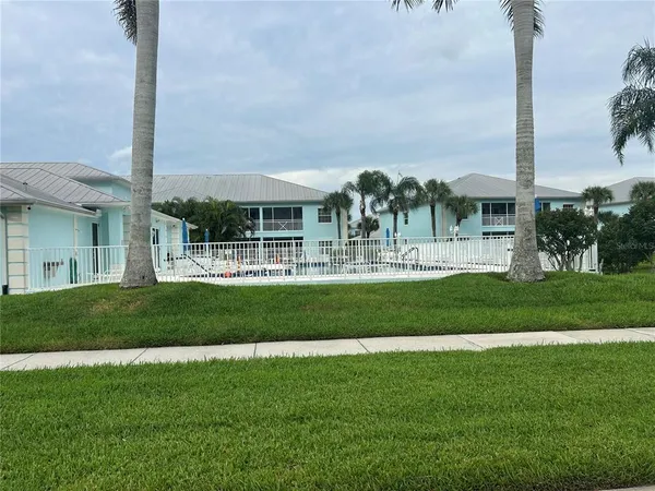 a kitchen with white cabinets and appliances