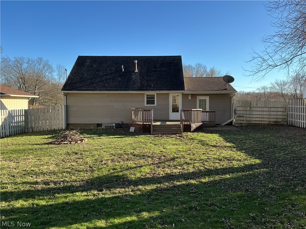 1850 Merle Road Salem, OH 44460 - Photo 29 of 35 Rear view of house with a fenced backyard, a wooden deck, and roof with shingles