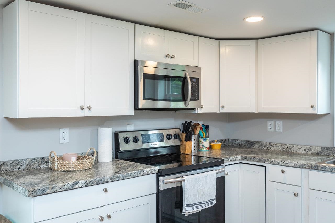 7452 Briery Branch Road Dayton, VA 22821 - Photo 11 of 66 a kitchen with granite countertop white cabinets and white appliances