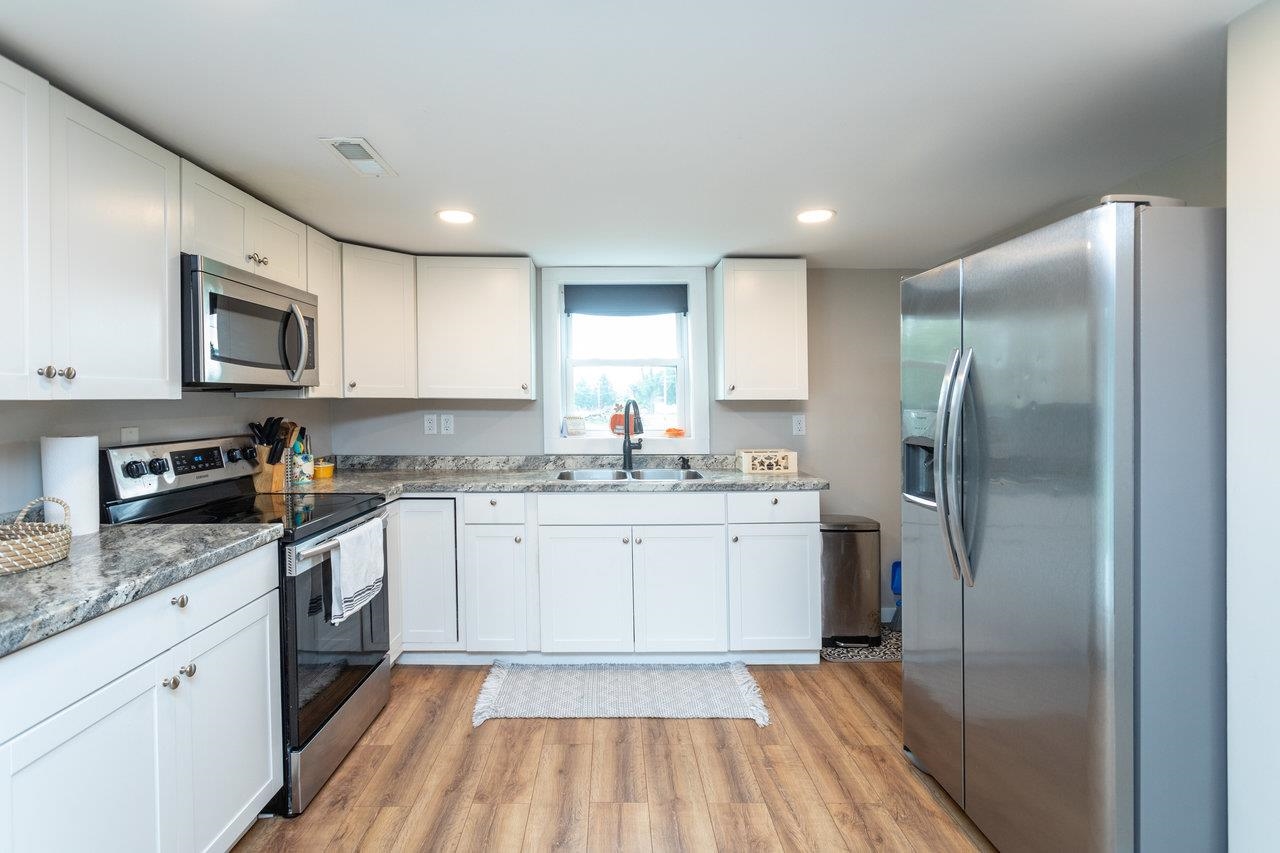 7452 Briery Branch Road Dayton, VA 22821 - Photo 12 of 66 a kitchen with granite countertop a refrigerator stove top oven and sink