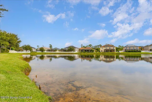 a view of a lake with houses in the background