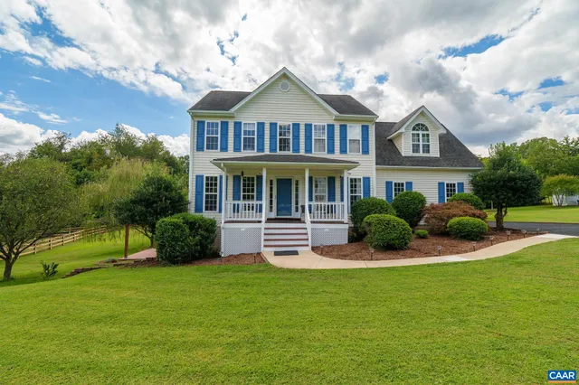 a front view of a house with a yard table and chairs