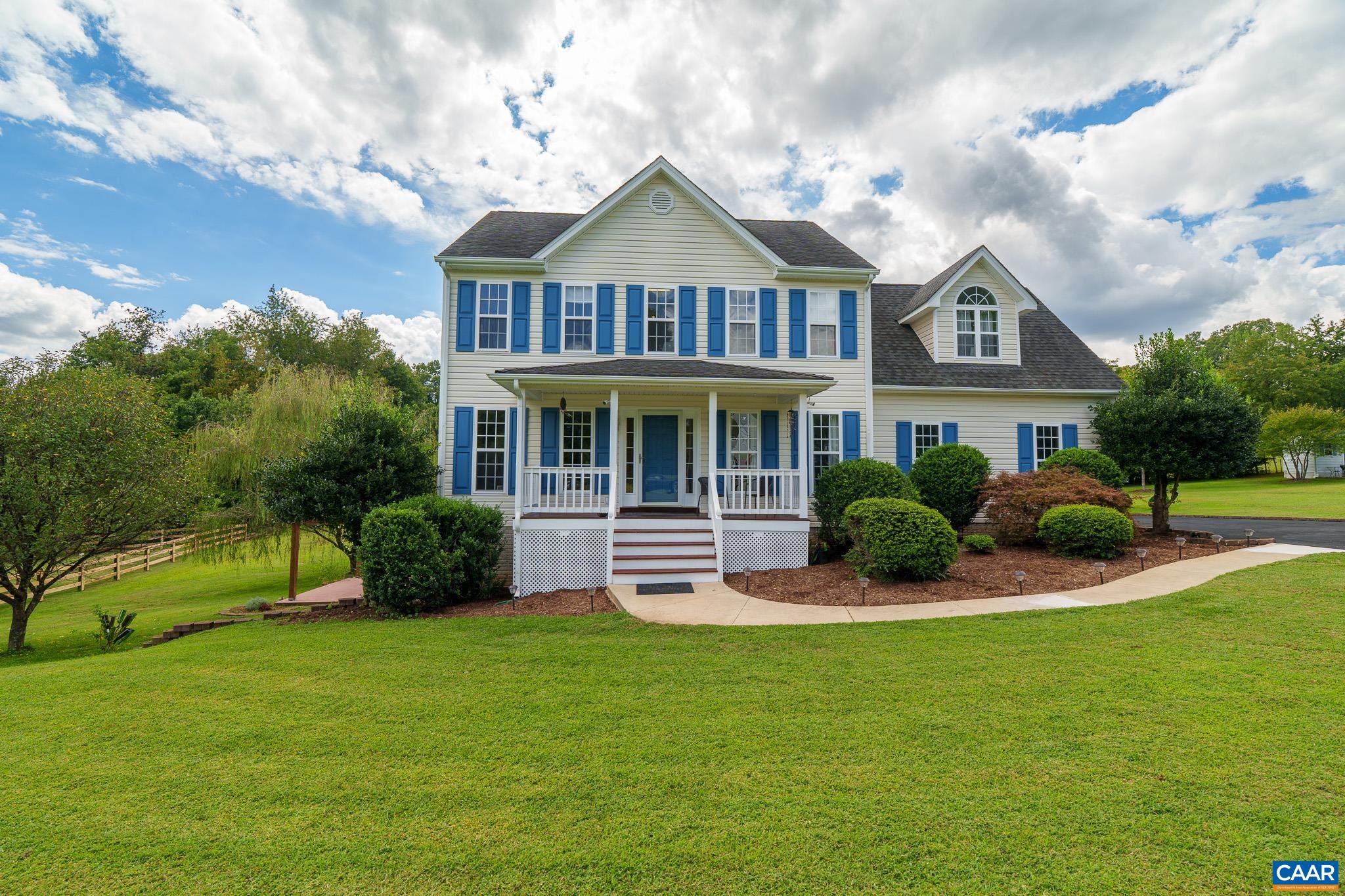 a front view of a house with a yard table and chairs