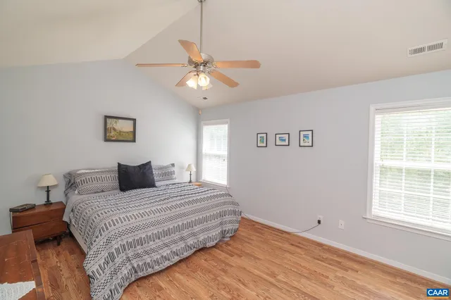 a view of a livingroom with wooden floor and white walls