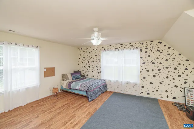 a kitchen with a sink and wooden floor