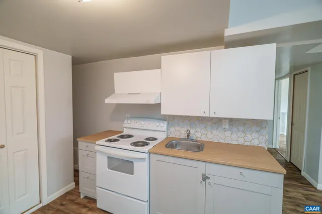 a bathroom with a glass door shower and a sink