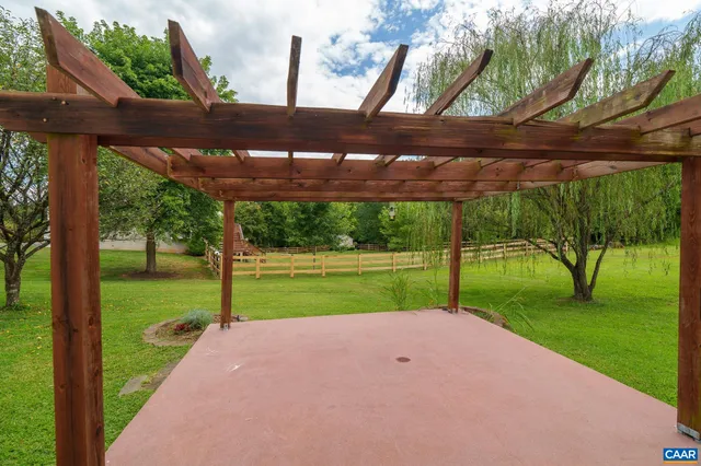 an aerial view of a house with swimming pool outdoor seating and yard