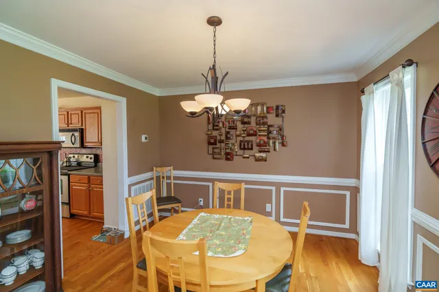 a view of a livingroom with furniture wooden floor a chandelier