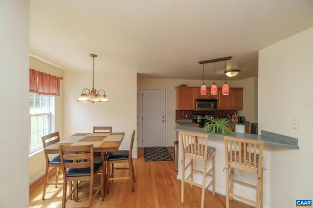 a living room with furniture a flat screen tv and kitchen view