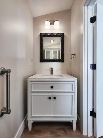 a bathroom with a sink and a mirror