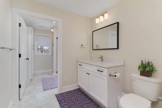 a bathroom with a toilet sink and shower