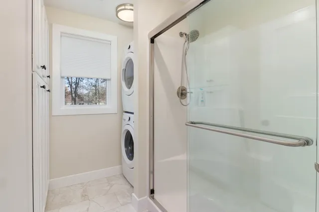 a bathroom with a shower and a mirror