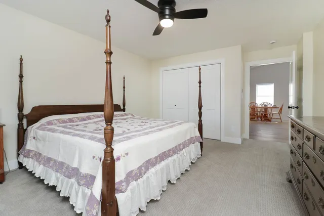 a bedroom with bed and a chandelier