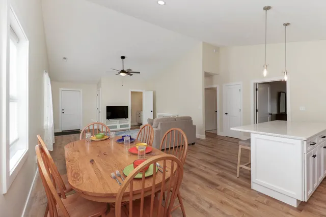 a dining room with furniture and wooden floor