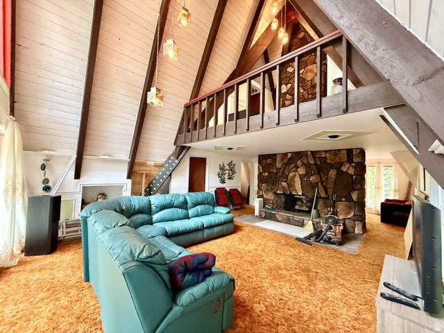 12498 East Wilderness Road Brighton, UT 84121 - Photo 39 of 40 Vaulted wood-paneled ceilings with exposed beams, stone fireplace, and a loft space with wood railing