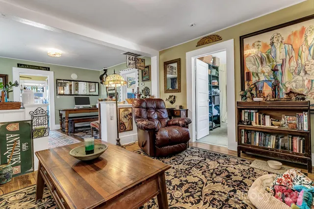 a living room with furniture and wooden floor