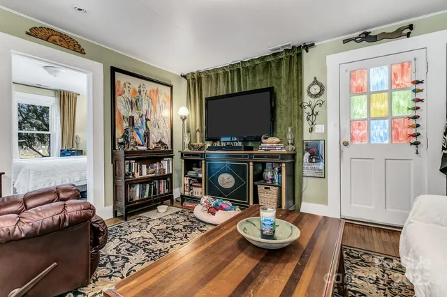 a front view of a house with a yard and potted plants
