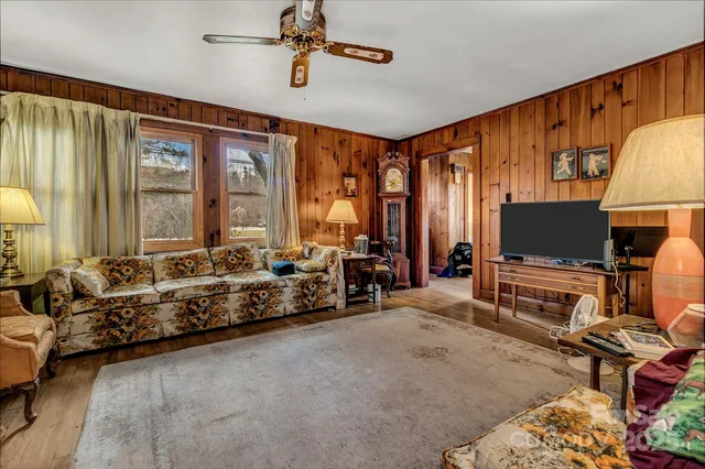 a living room with furniture a rug and a painting on the wall