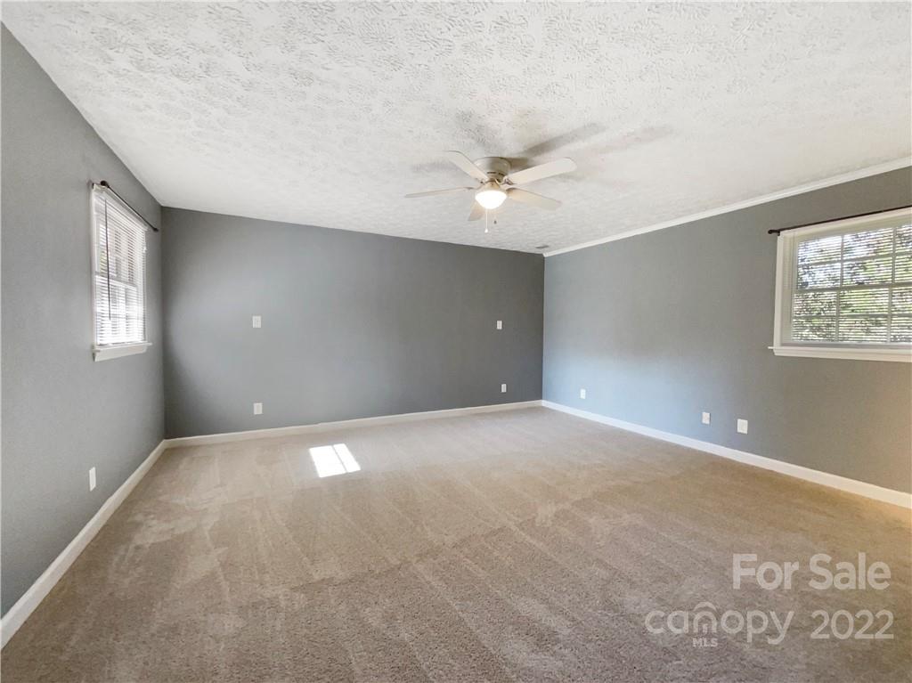 540 Neel Road Salisbury, NC 28147 - Photo 11 of 22 an empty room with windows and ceiling fan