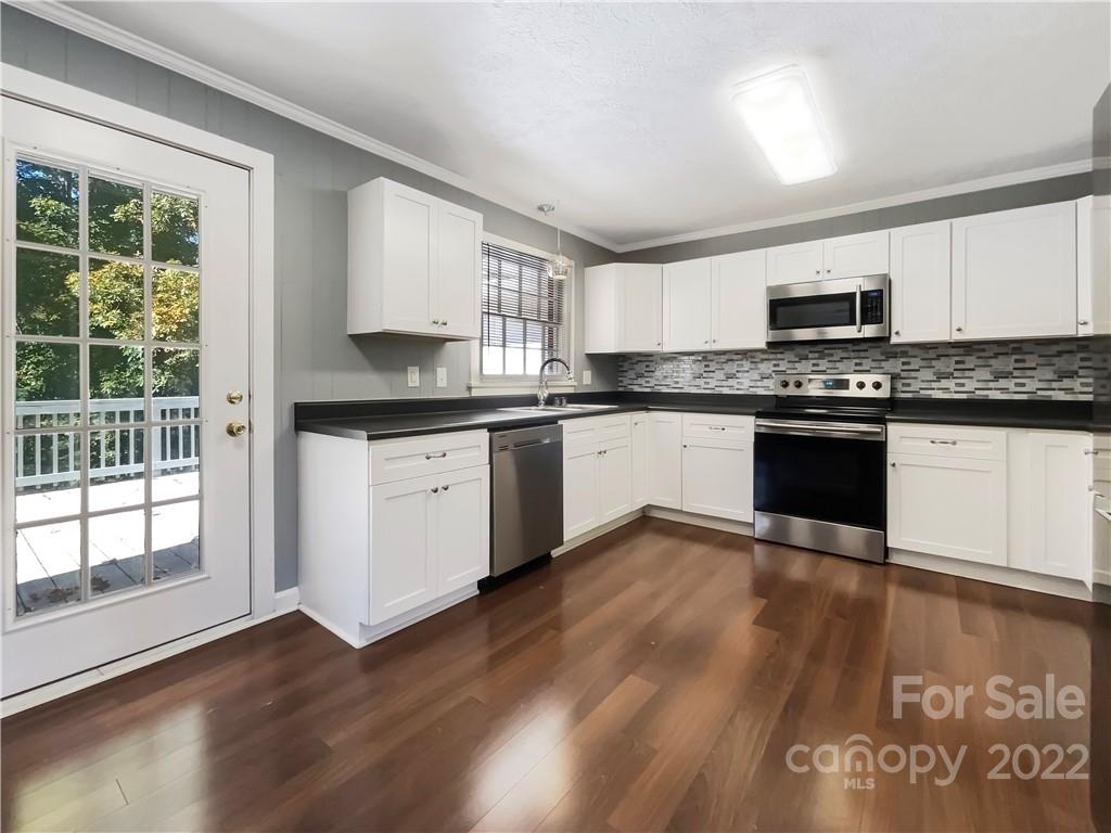 540 Neel Road Salisbury, NC 28147 - Photo 4 of 22 a kitchen with granite countertop stainless steel appliances and wooden cabinets