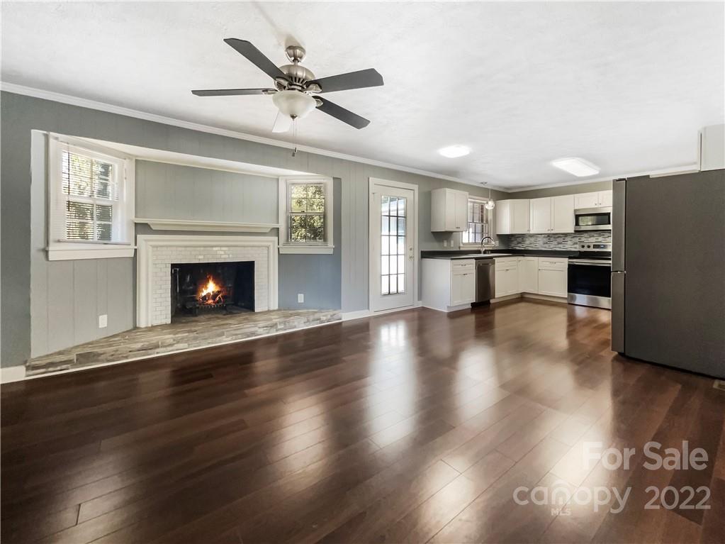 540 Neel Road Salisbury, NC 28147 - Photo 5 of 22 a living room with stainless steel appliances wooden floor and a fireplace