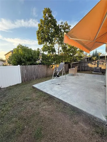 a view of a backyard with sitting area and furniture