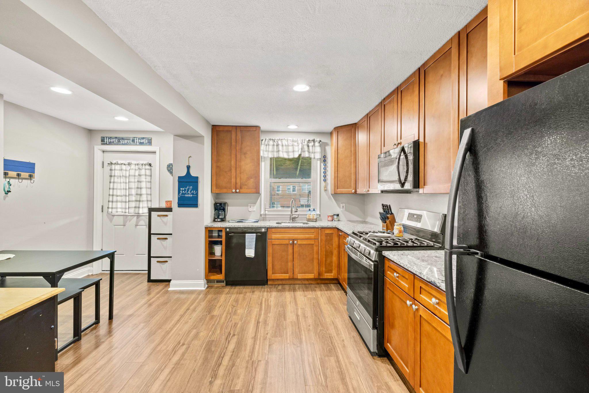 234 West Edgevale Road Baltimore, MD 21225 - Photo 6 of 45 Modern kitchen with warm wood tones.