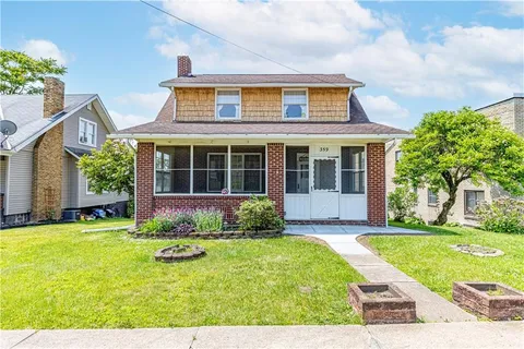 a view of a house with swimming pool and yard
