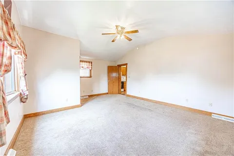 an empty room with windows and cabinet