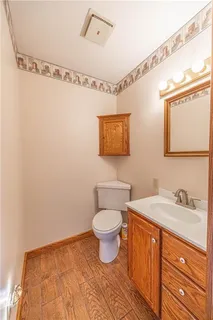 a bathroom with a toilet sink and mirror