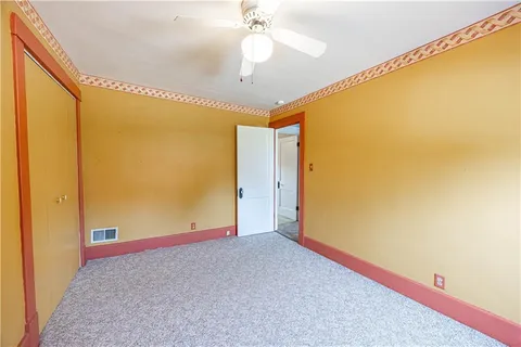 a view of room with a ceiling fan