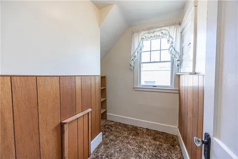 a view of entryway with wooden floor and staircase