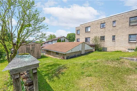 a aerial view of a house with yard and deck