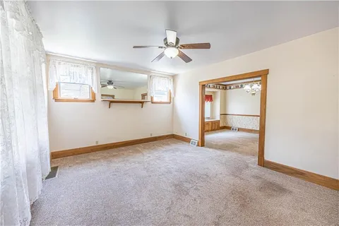a view of a livingroom with a ceiling fan and window