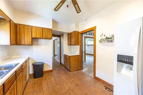 a hallway with a sink and cabinets