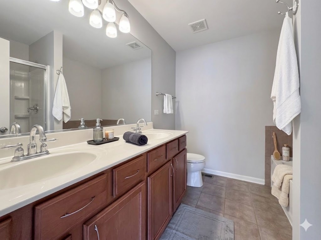 3381 Cameron Drive Elgin, IL 60124 - Photo 15 of 23 a bathroom with a double vanity sink and a mirror