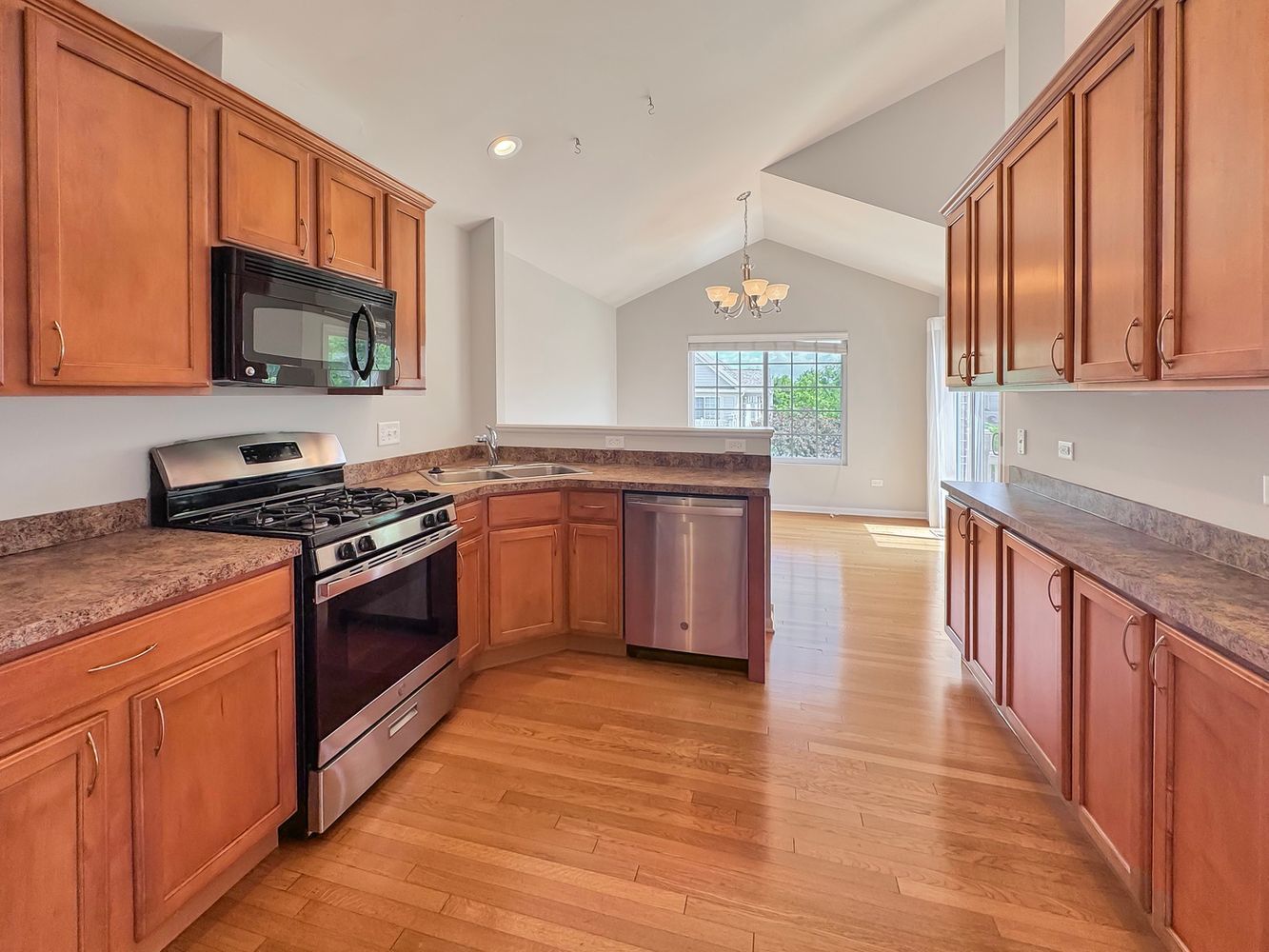 3381 Cameron Drive Elgin, IL 60124 - Photo 9 of 23 a kitchen with stainless steel appliances granite countertop a stove a sink and a microwave