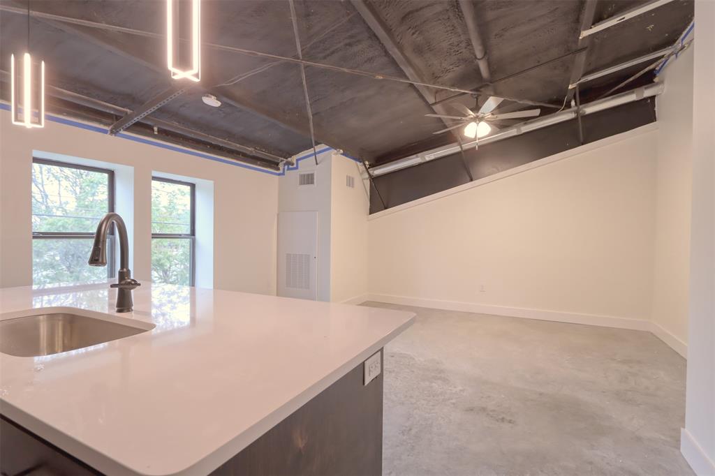 301 West Main Street Midlothian, TX 76065 - Photo 2 of 6 Kitchen with concrete floors and ceiling fan