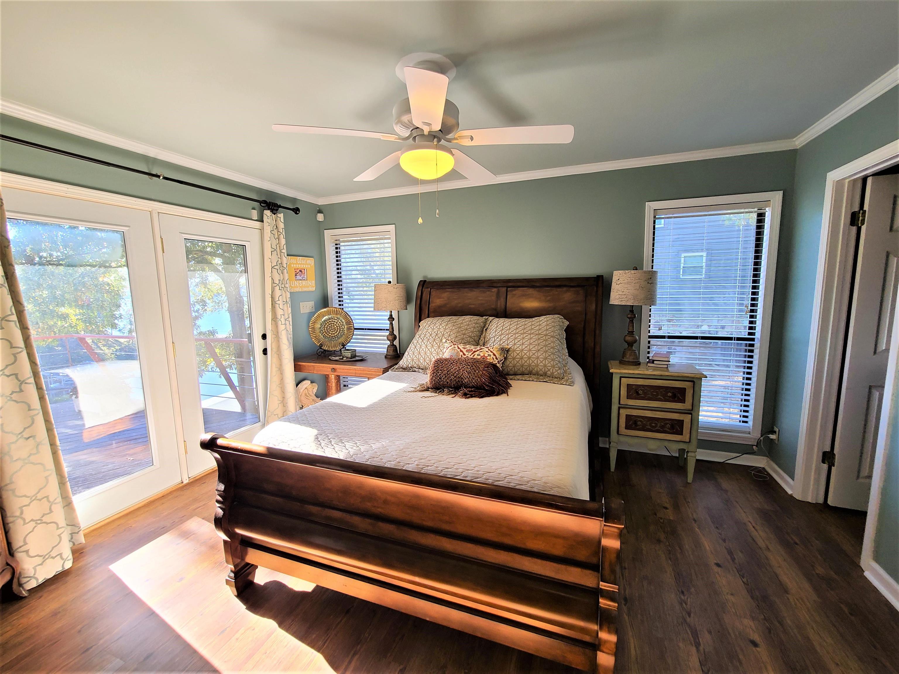 90 Riviera Cove Cherokee, AL 35616 - Photo 11 of 21 a bedroom with a bed and a chandelier