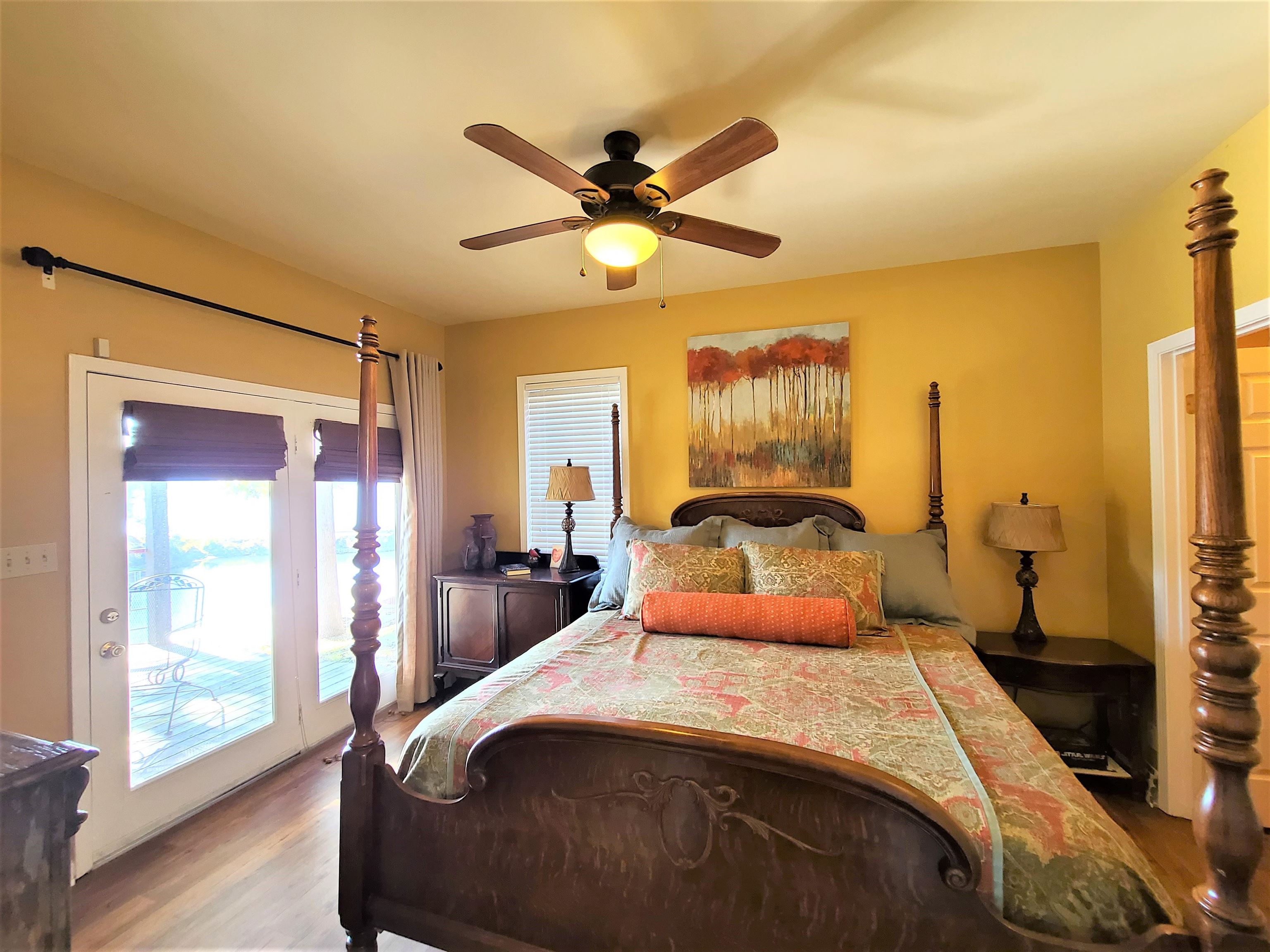90 Riviera Cove Cherokee, AL 35616 - Photo 14 of 21 a bedroom with a bed and a chandelier