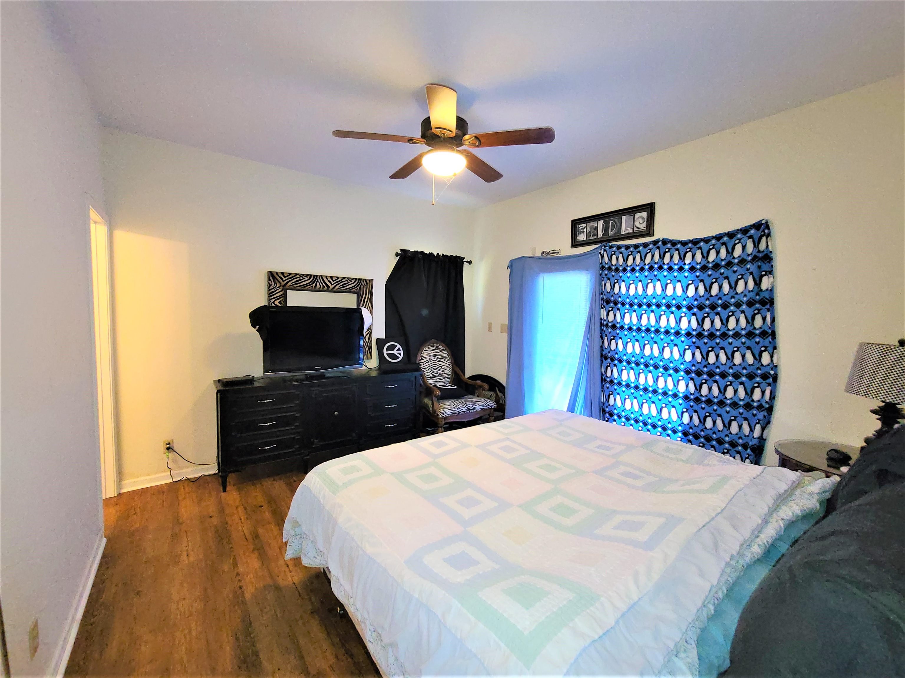 90 Riviera Cove Cherokee, AL 35616 - Photo 16 of 21 a bedroom with a bed and a flat tv screen on dresser