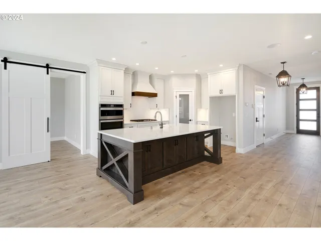 a kitchen with kitchen island cabinets and refrigerator