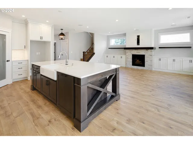 a large white kitchen with a stove top oven