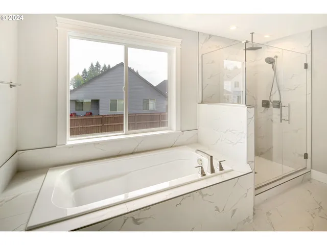 a bathroom with a tub sink and shower