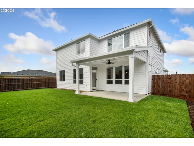 a view of a house with a yard and sitting area