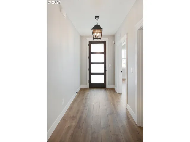 a view of a room that has a wooden floor and window