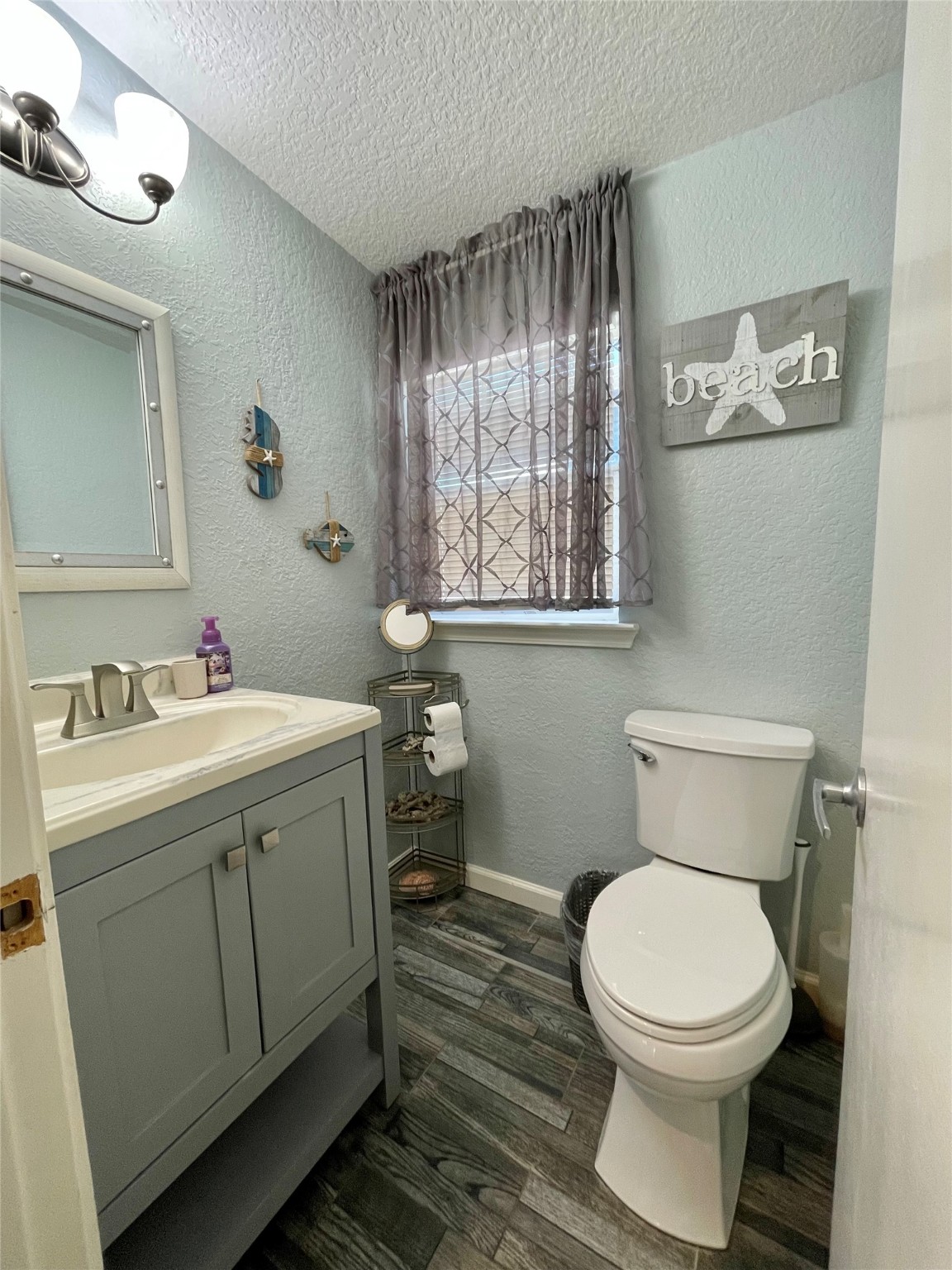 308 Parkview Road Surfside Beach, TX 77541 - Photo 12 of 18 a bathroom with a toilet sink and mirror