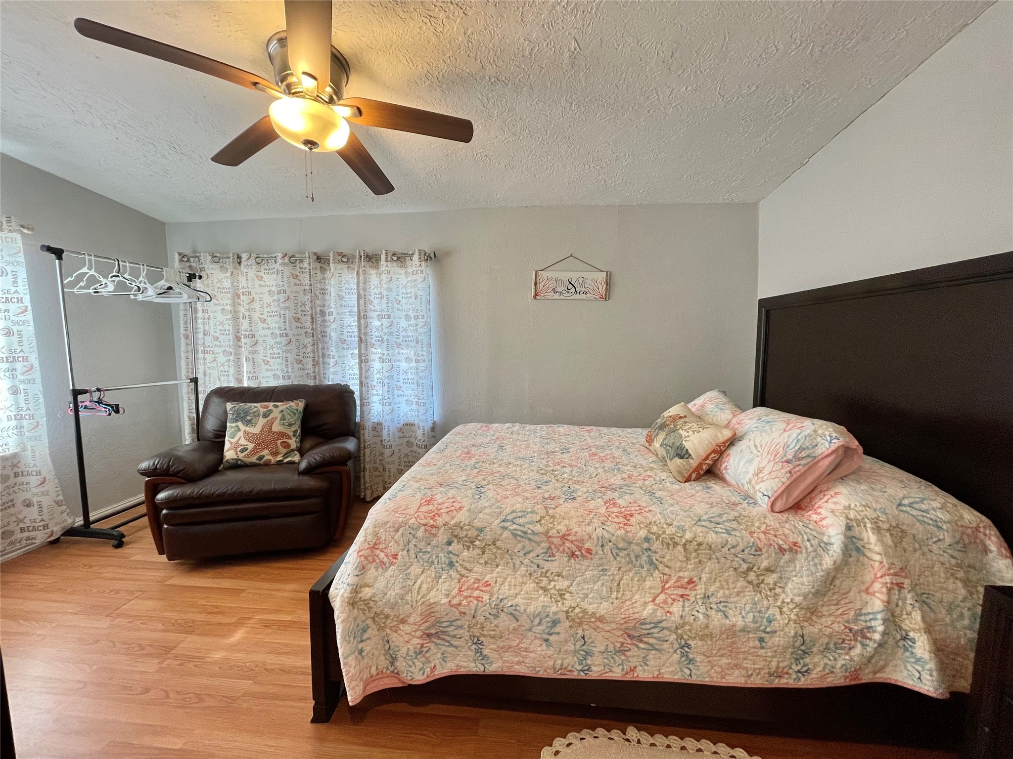 308 Parkview Road Surfside Beach, TX 77541 - Photo 17 of 18 a bedroom with a bed and a chandelier